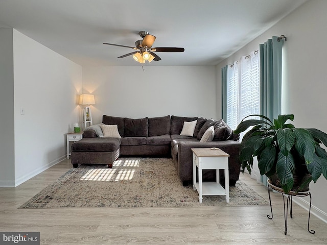 8565 E St, Chesapeake Beach, MD 20732 - living room featuring wood finished floors, ceiling fan, and baseboards