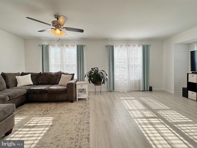 8565 E St, Chesapeake Beach, MD 20732 - living room with wood finished floors, ceiling fan, and baseboards