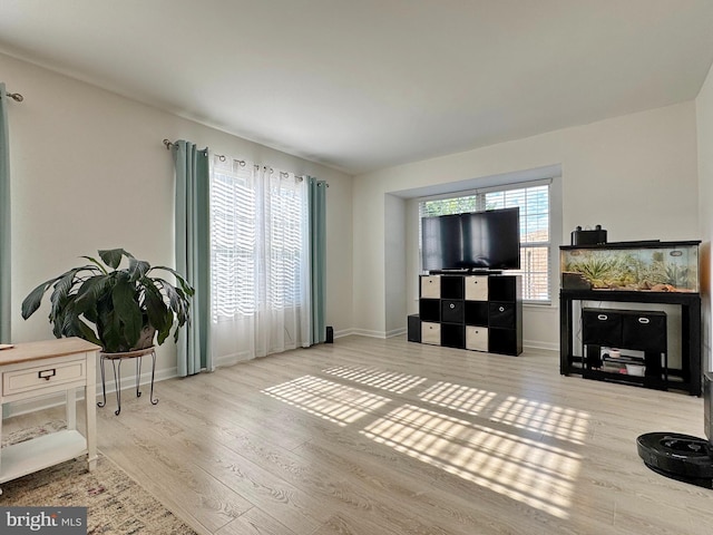 8565 E St, Chesapeake Beach, MD 20732 - living area featuring wood finished floors, healthy amount of natural light, and baseboards