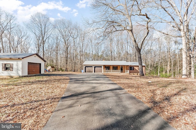 15180 Deborah Dr, Hughesville, MD 20637 - single story home with covered porch, a detached garage, an outdoor structure, and asphalt driveway