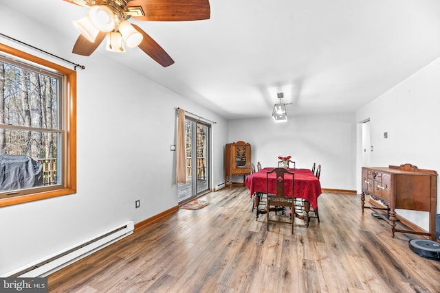 15180 Deborah Dr, Hughesville, MD 20637 - dining room featuring a baseboard radiator, wood finished floors, baseboards, and ceiling fan