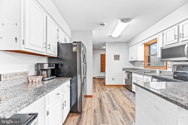 15180 Deborah Dr, Hughesville, MD 20637 - kitchen featuring stainless steel appliances, a sink, white cabinets, light wood-style flooring, and a baseboard radiator