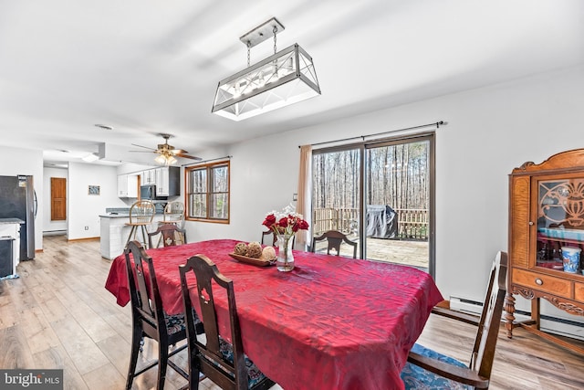 15180 Deborah Dr, Hughesville, MD 20637 - dining area with light wood-style floors, a baseboard heating unit, and a ceiling fan