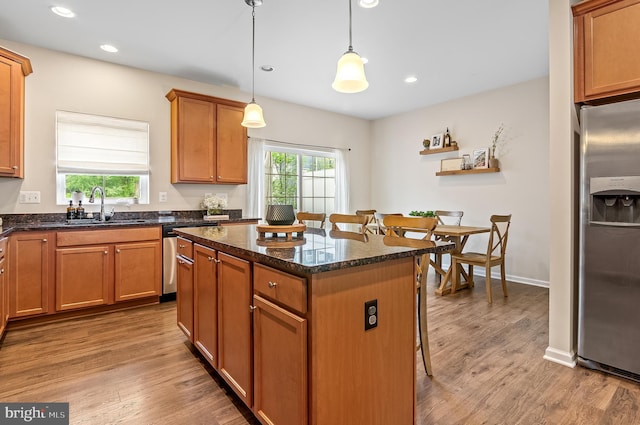 1022 Linden Dr, Hanover, MD 21076 - kitchen with stainless steel appliances, a kitchen island, light wood-style floors, a kitchen bar, and recessed lighting