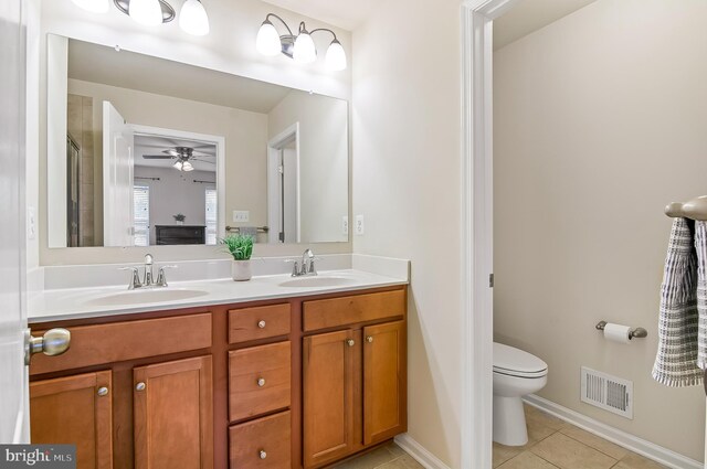 1022 Linden Dr, Hanover, MD 21076 - full bath featuring double vanity, tile patterned floors, toilet, ceiling fan, and baseboards
