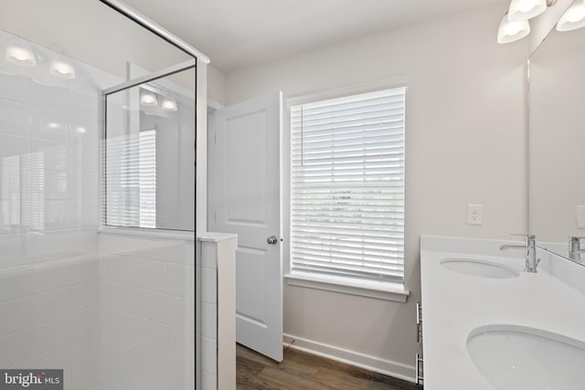 16612 Green Glade Dr, Brandywine, MD 20613 - full bathroom featuring a tile shower, double vanity, wood finished floors, and baseboards
