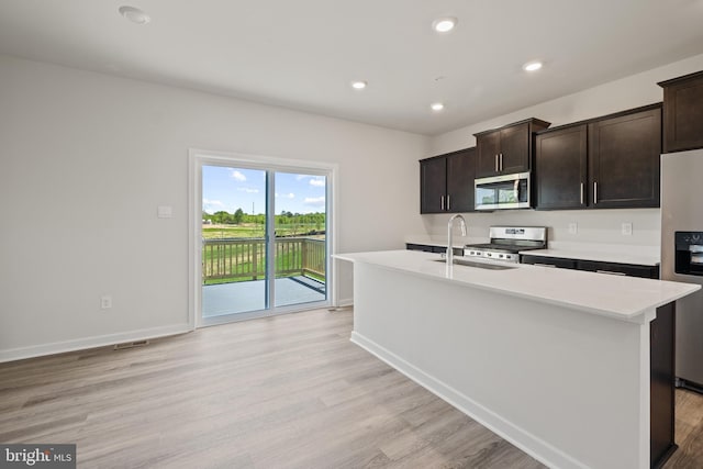 16612 Green Glade Dr, Brandywine, MD 20613 - kitchen featuring appliances with stainless steel finishes, light countertops, light wood-style flooring, a sink, and baseboards