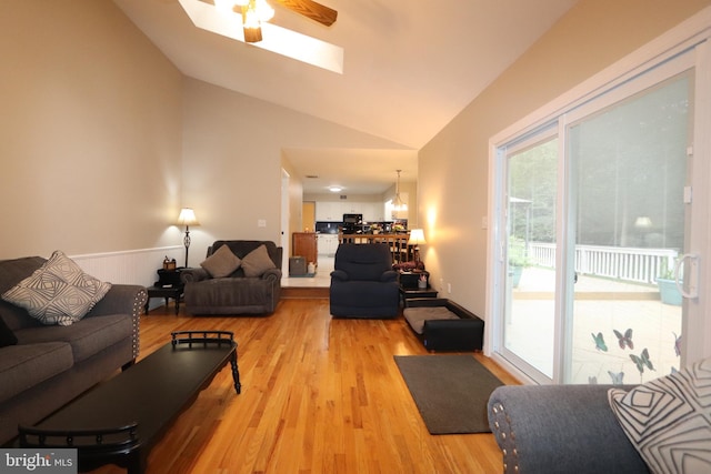 2320 Knotweed Ct, Waldorf, MD 20603 - living area featuring lofted ceiling, light wood-style flooring, a skylight, a wainscoted wall, and ceiling fan