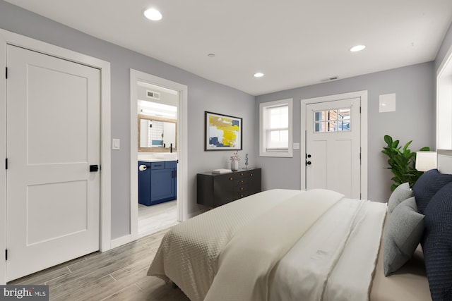 909 Webster St NW Unit 1, Washington, DC 20011 - bedroom with light wood finished floors, recessed lighting, ensuite bath, and baseboards