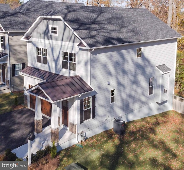 0000 Sadie Way, Arnold, MD 21012 - traditional home with covered porch, a standing seam roof, an attached garage, a shingled roof, and metal roof