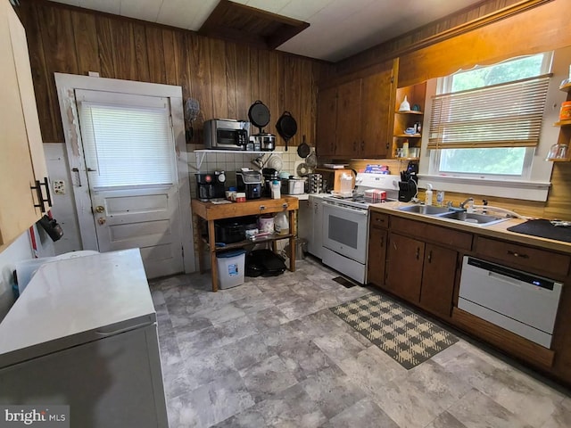2411 Washington Ave, Victoria, VA 23974 - kitchen featuring white appliances, a sink, wood walls, open shelves, and light countertops
