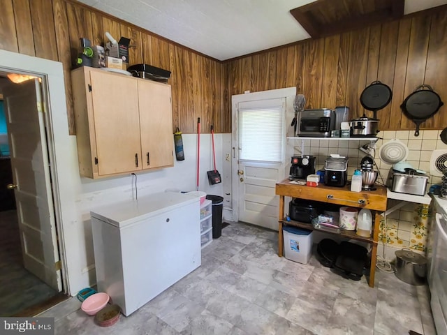 2411 Washington Ave, Victoria, VA 23974 - kitchen featuring white fridge, wooden walls, and light countertops