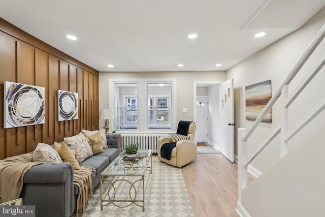 207 W Albanus St, Philadelphia, PA 19120 - living area featuring radiator heating unit, light wood finished floors, recessed lighting, and stairway