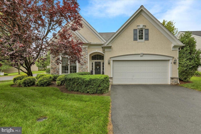213 Aster Cir, Kennett Square, PA 19348 - view of front facade featuring stone siding, asphalt driveway, a front yard, and stucco siding