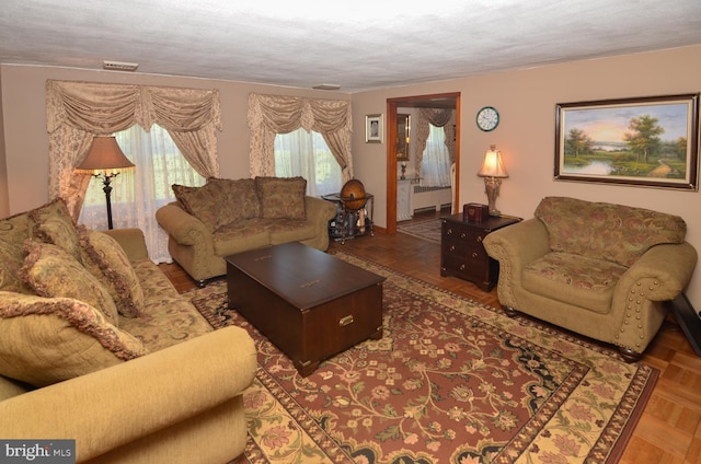 1009 Potts Mill Rd, Bordentown, NJ 08505 - living area with radiator, plenty of natural light, and a textured ceiling