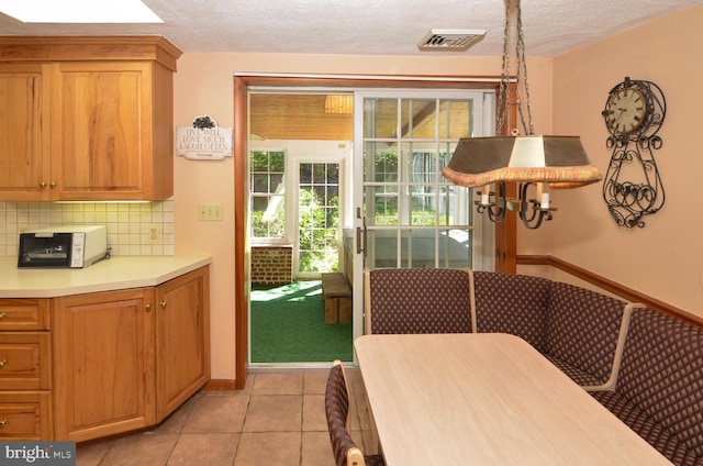 1009 Potts Mill Rd, Bordentown, NJ 08505 - dining area featuring light tile patterned floors and a textured ceiling