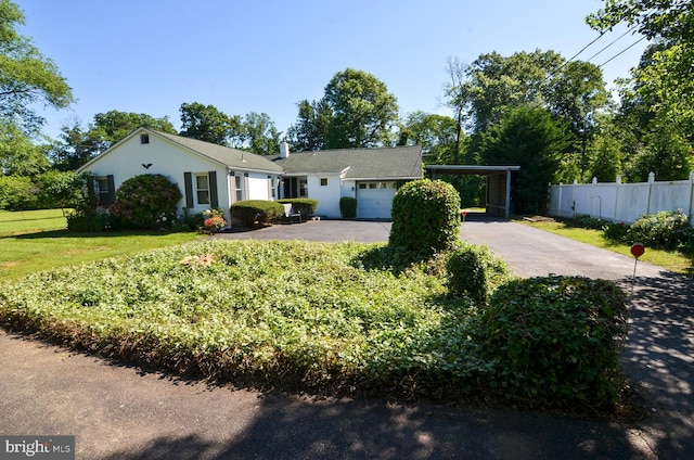 1009 Potts Mill Rd, Bordentown, NJ 08505 - ranch-style home featuring asphalt driveway, a carport, an attached garage, and stucco siding