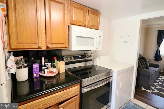 2460 Kilpatrick Pl, Dumfries, VA 22026 - kitchen with white microwave, stainless steel electric range, independent washer and dryer, tile patterned floors, and ornamental molding