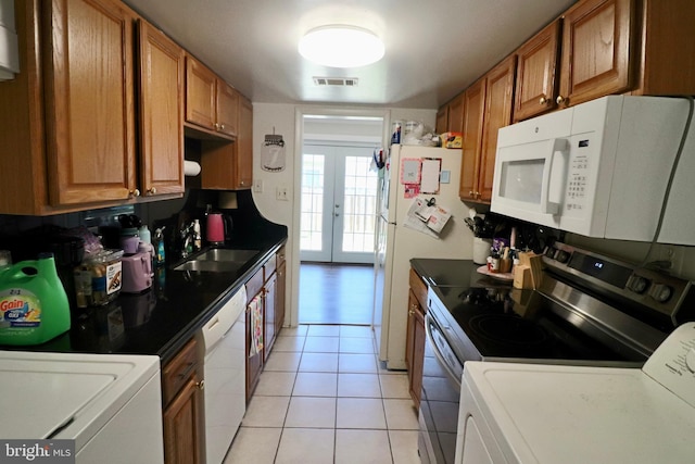 2460 Kilpatrick Pl, Dumfries, VA 22026 - kitchen featuring white appliances, a sink, french doors, and brown cabinetry