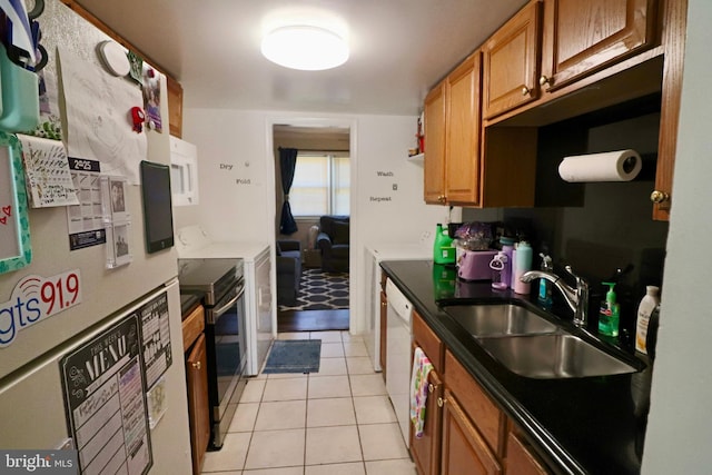 2460 Kilpatrick Pl, Dumfries, VA 22026 - kitchen with a sink, white appliances, light tile patterned floors, and brown cabinets