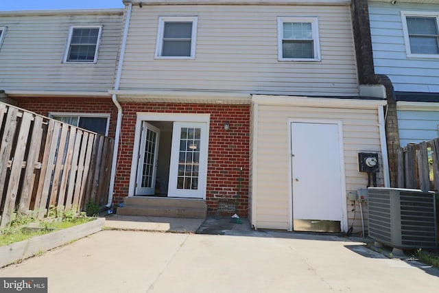 2460 Kilpatrick Pl, Dumfries, VA 22026 - back of property featuring brick siding, cooling unit, a patio, and entry steps