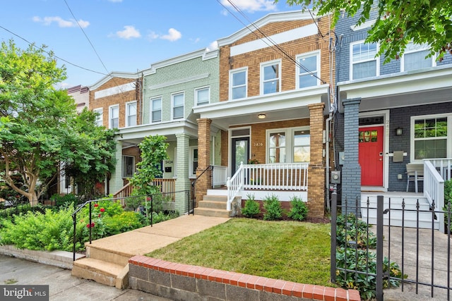 2426 4th St NE, Washington, DC 20002 - view of property with a porch, brick siding, and a front lawn