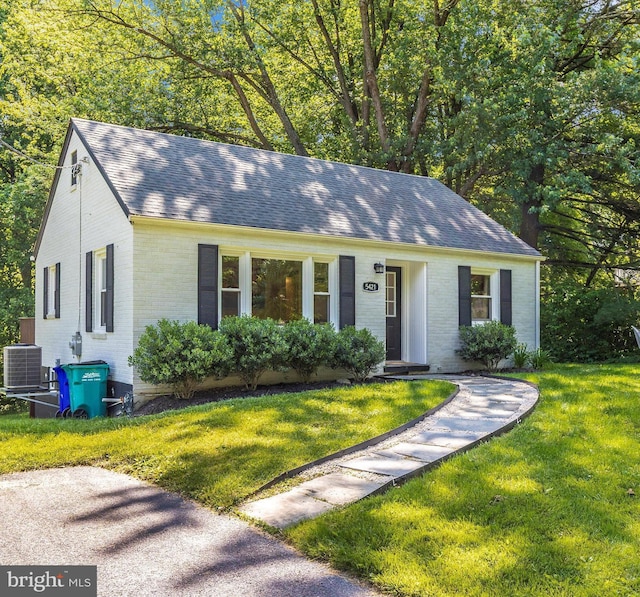 5421 Bartonsville Rd, Frederick, MD 21704 - view of front of property featuring brick siding, central AC unit, roof with shingles, and a front yard