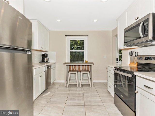 5421 Bartonsville Rd, Frederick, MD 21704 - kitchen with stainless steel appliances, backsplash, light countertops, white cabinetry, and recessed lighting