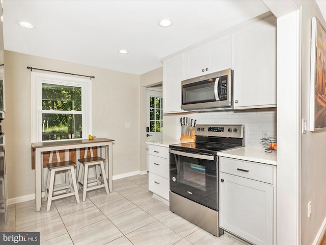 5421 Bartonsville Rd, Frederick, MD 21704 - kitchen featuring stainless steel appliances, decorative backsplash, light countertops, baseboards, and recessed lighting