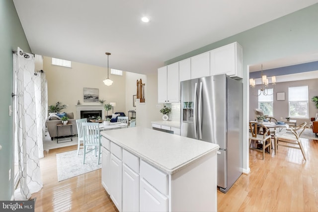 35551 Sarasota St, Round Hill, VA 20141 - kitchen featuring stainless steel refrigerator with ice dispenser, open floor plan, light wood-type flooring, a kitchen island, and recessed lighting