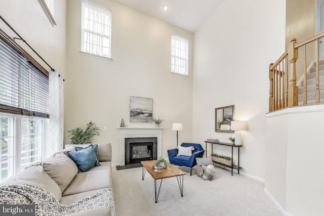 35551 Sarasota St, Round Hill, VA 20141 - living area with a high ceiling, a fireplace with flush hearth, carpet floors, baseboards, and stairway