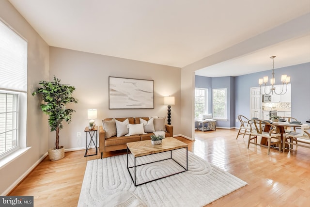 35551 Sarasota St, Round Hill, VA 20141 - living room with light wood-style floors, a chandelier, and baseboards