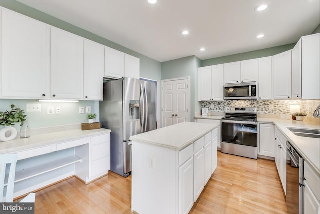 35551 Sarasota St, Round Hill, VA 20141 - kitchen featuring appliances with stainless steel finishes, a sink, a center island, light wood finished floors, and backsplash
