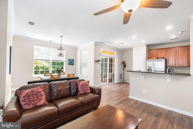 43825 Hickory Corner Ter Unit 104, Ashburn, VA 20147 - living area with baseboards, wood finished floors, ornamental molding, recessed lighting, and a ceiling fan