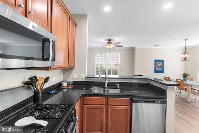 43825 Hickory Corner Ter Unit 104, Ashburn, VA 20147 - kitchen with stainless steel appliances, a sink, a peninsula, crown molding, and brown cabinets