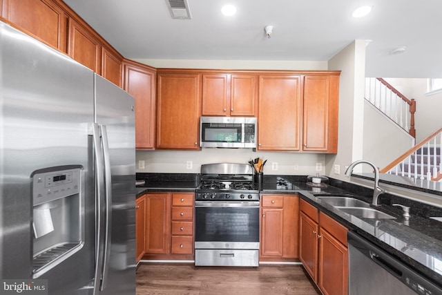 43825 Hickory Corner Ter Unit 104, Ashburn, VA 20147 - kitchen with appliances with stainless steel finishes, a sink, dark wood finished floors, dark stone countertops, and recessed lighting