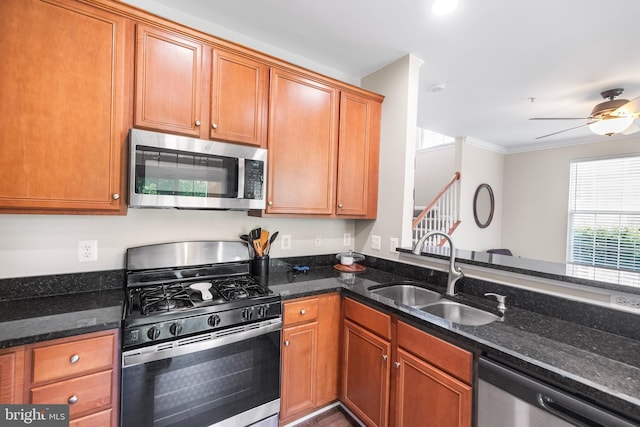 43825 Hickory Corner Ter Unit 104, Ashburn, VA 20147 - kitchen featuring appliances with stainless steel finishes, a sink, dark stone counters, ceiling fan, and brown cabinets
