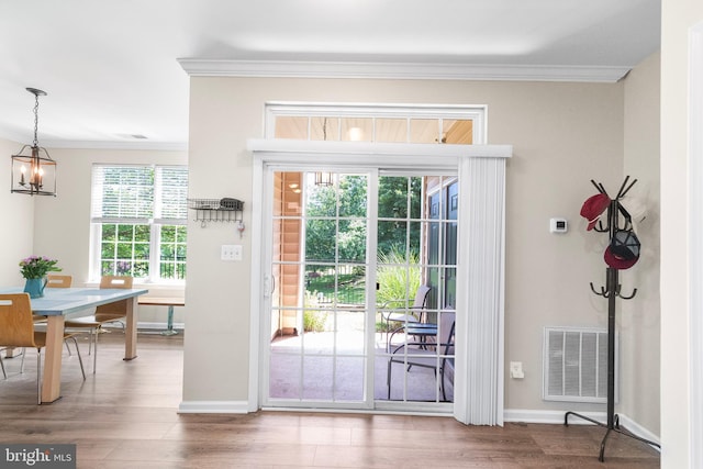 43825 Hickory Corner Ter Unit 104, Ashburn, VA 20147 - doorway to outside with ornamental molding, wood finished floors, baseboards, and a chandelier