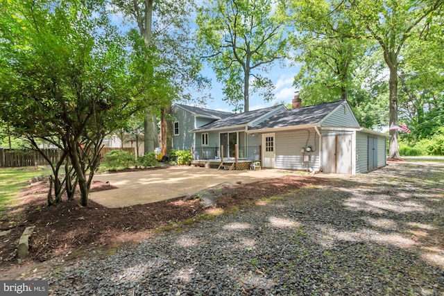 4097 Shoreham Beach Rd, Edgewater, MD 21037 - back of property with a chimney and a garage