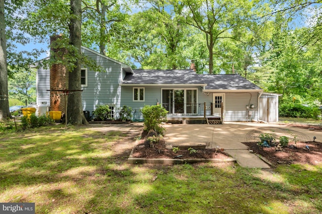 4097 Shoreham Beach Rd, Edgewater, MD 21037 - rear view of property featuring a chimney, a wooden deck, a yard, and a patio