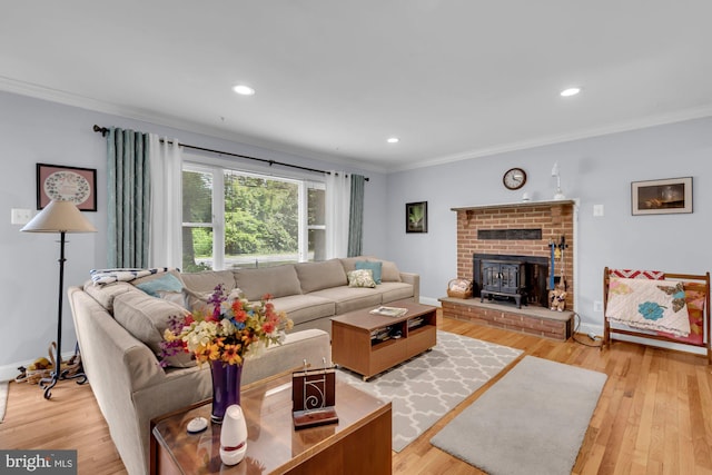 4097 Shoreham Beach Rd, Edgewater, MD 21037 - living area with crown molding, light wood finished floors, a wood stove, recessed lighting, and baseboards
