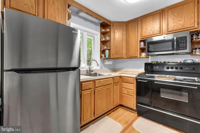 4097 Shoreham Beach Rd, Edgewater, MD 21037 - kitchen with stainless steel appliances, open shelves, a sink, light countertops, and light wood-style floors