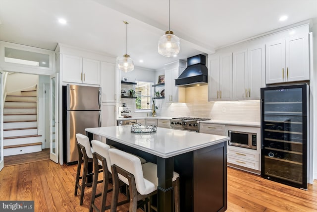 1157 Riverside Ave, Baltimore, MD 21230 - kitchen featuring premium range hood, beverage cooler, stainless steel appliances, tasteful backsplash, and light countertops