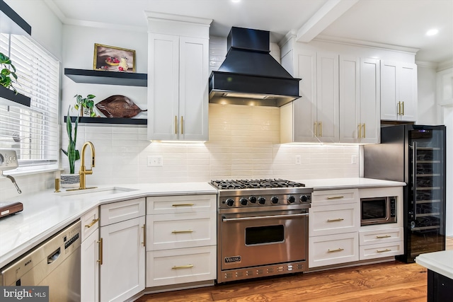 1157 Riverside Ave, Baltimore, MD 21230 - kitchen featuring stainless steel appliances, premium range hood, open shelves, white cabinetry, and crown molding