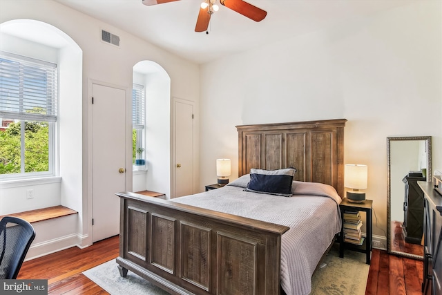 1157 Riverside Ave, Baltimore, MD 21230 - bedroom with arched walkways, dark wood-style floors, baseboards, and a ceiling fan