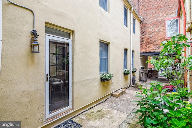 1157 Riverside Ave, Baltimore, MD 21230 - doorway to property featuring stucco siding and a patio