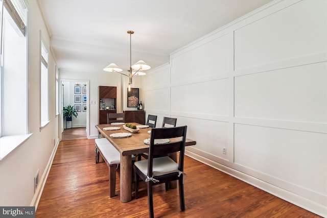 1157 Riverside Ave, Baltimore, MD 21230 - dining area featuring a decorative wall, wood finished floors, baseboards, and crown molding