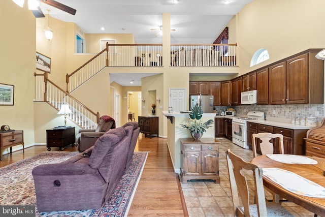 4 Hearthstone Blvd, Pemberton, NJ 08068 - kitchen featuring white appliances, ceiling fan, a towering ceiling, light countertops, and decorative backsplash