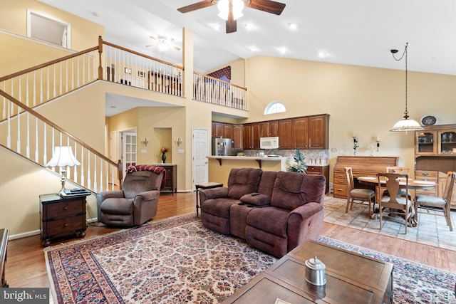 4 Hearthstone Blvd, Pemberton, NJ 08068 - living area with stairs, a ceiling fan, light wood-style flooring, and high vaulted ceiling