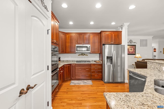 83 Mossy Creek Ct, Zion Crossroads, VA 22942 - kitchen with appliances with stainless steel finishes, ornamental molding, light wood-style floors, light stone countertops, and recessed lighting